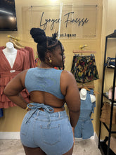 Load image into Gallery viewer, chic two-piece features a relaxed-fit denim pull over top with playful cutouts and high-waisted shorts
