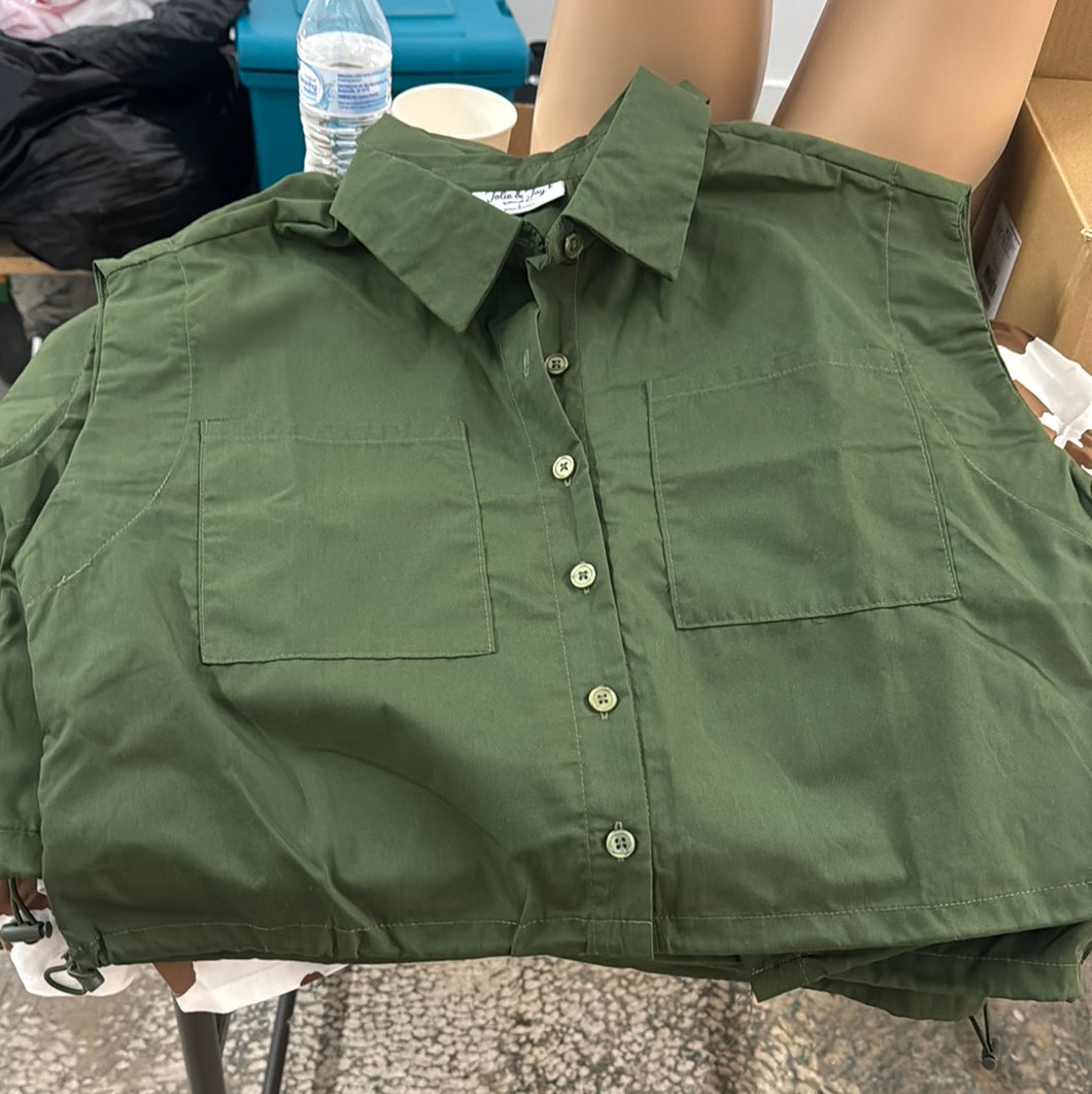 Olive green sleeveless button-up crop top with front pockets and drawstring hem, displayed flat on a table – Lynyce Finesse Boutique 2025