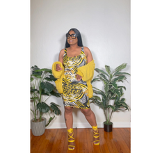 Load image into Gallery viewer, Side angle of model wearing floral midi dress displaying sleek fit and comfortable movement.
